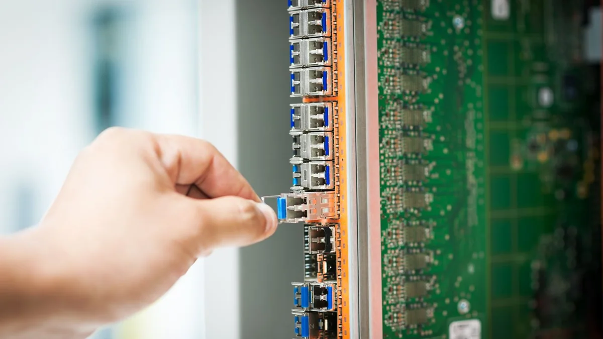 Engineer fixing core swith in data center room