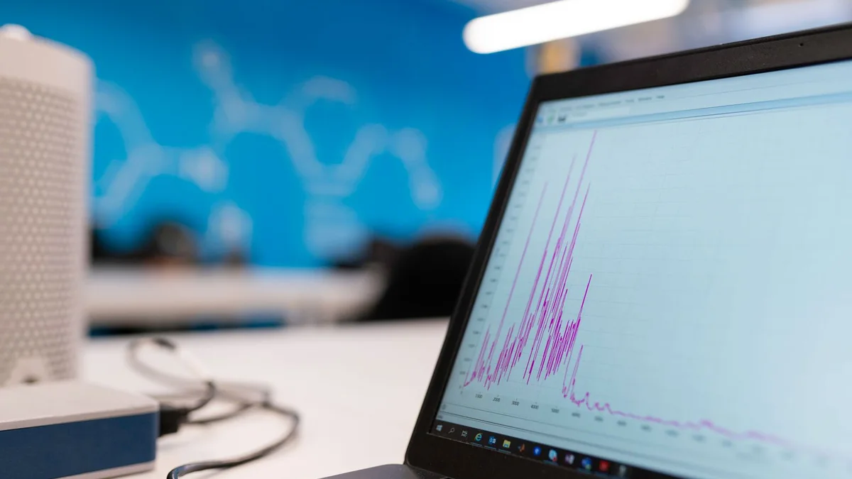 Laptop displaying a data graph in a technology workspace