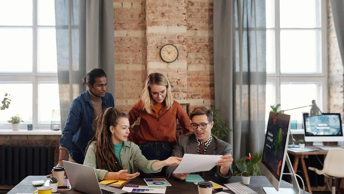 Creative professionals reviewing campaign materials in a bright studio