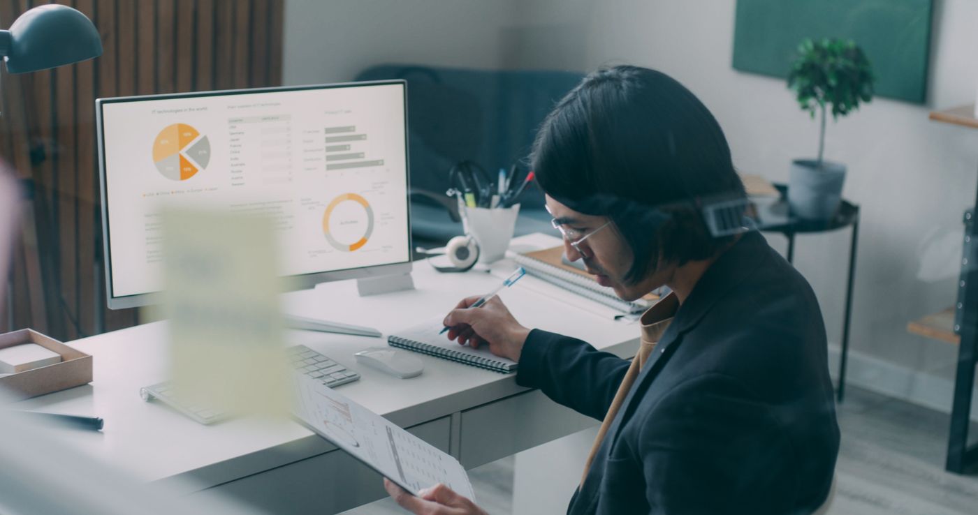 Business professional analyzing charts at desk