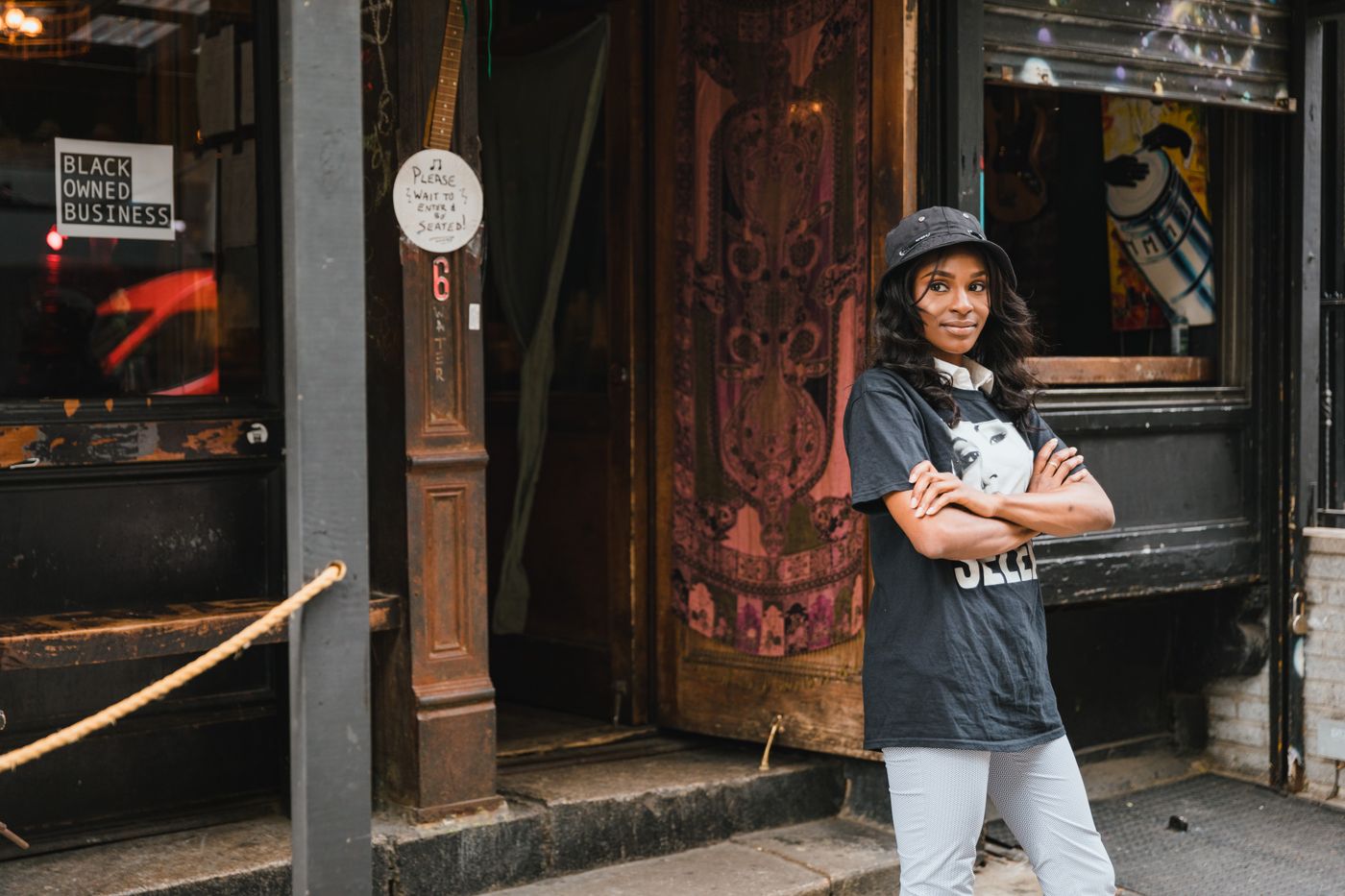 Portrait of Smiling FemaleÂ Owner in Front of Cafe