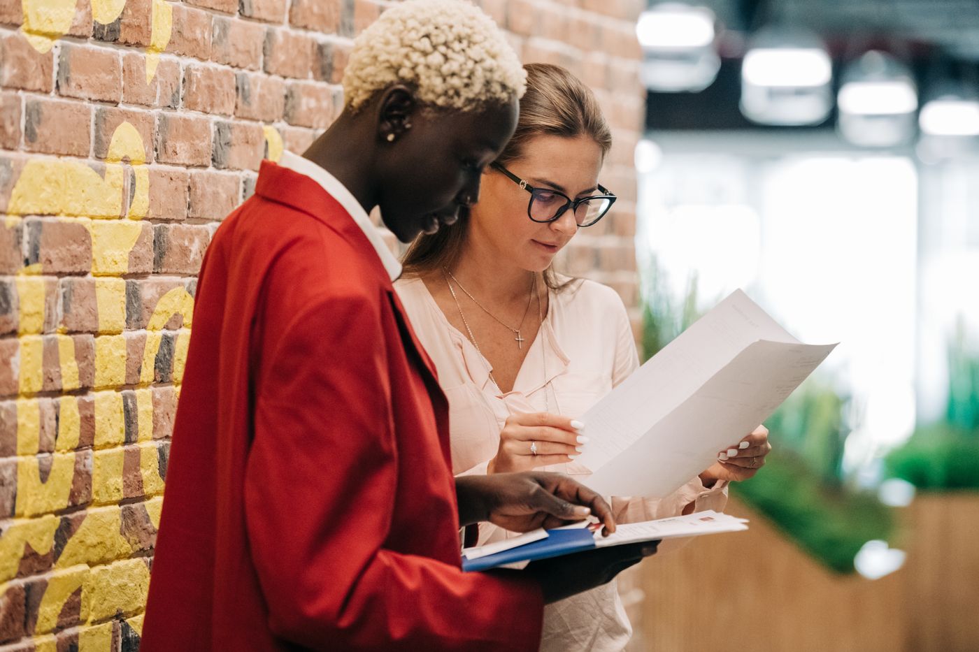Diverse businesswomen discussing contract on paper