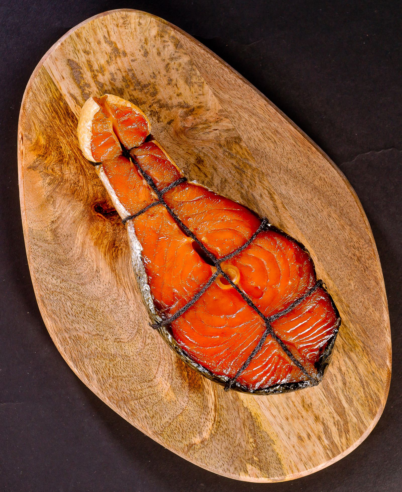 Prepared salmon on a wooden serving board — illustrative stock photo
