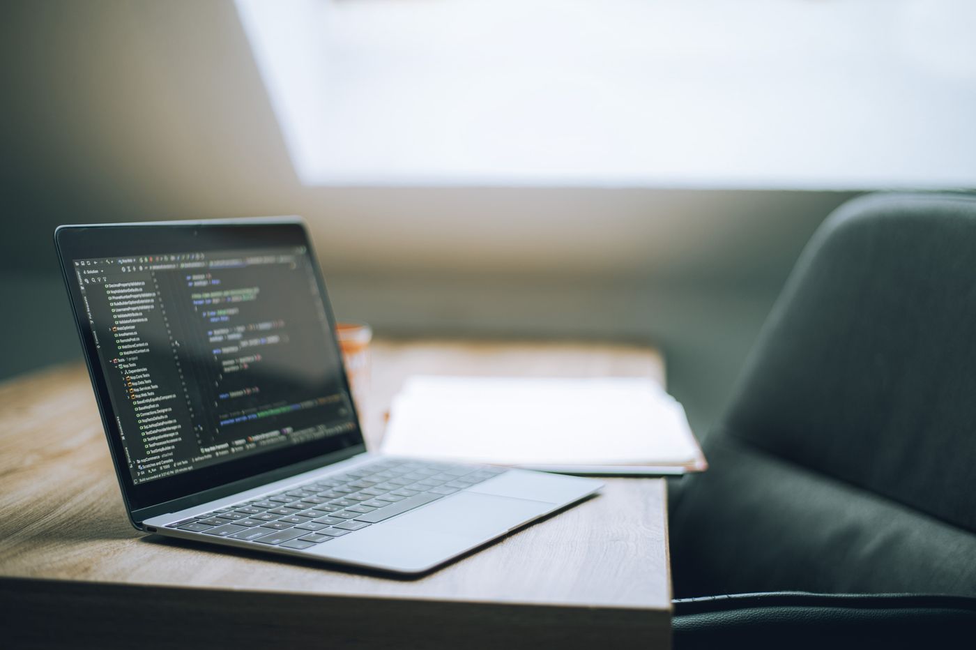 Modern Workspace with Laptop and Code Display