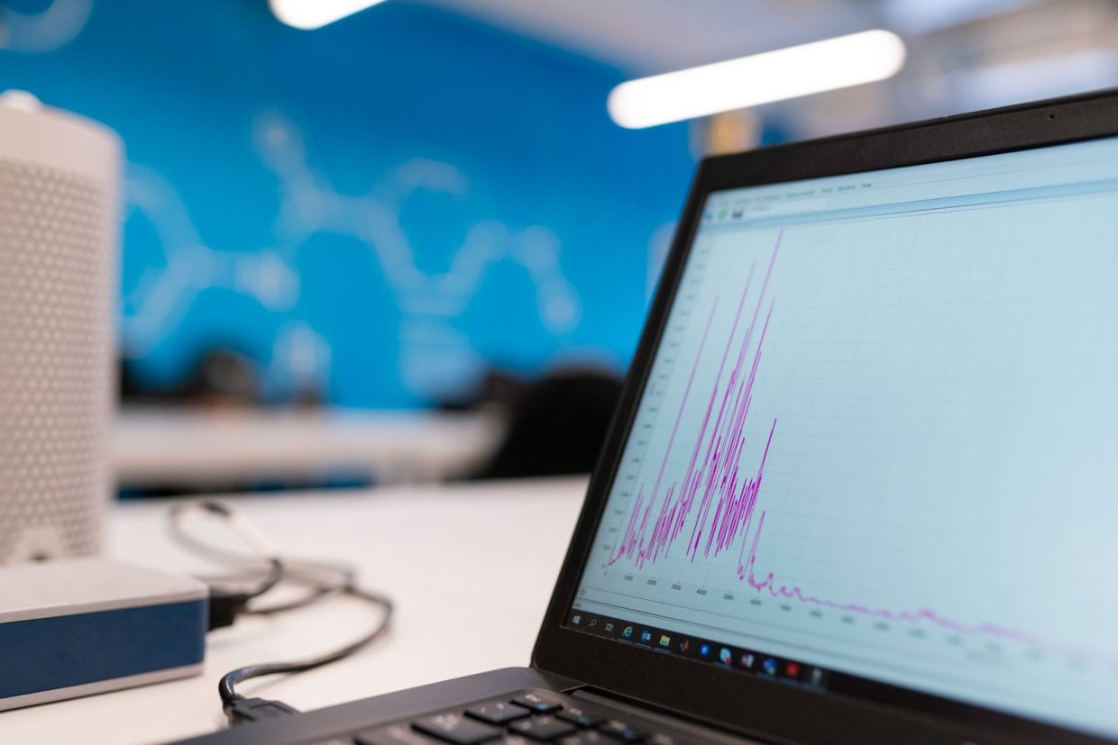 Laptop displaying a data graph in a technology workspace
